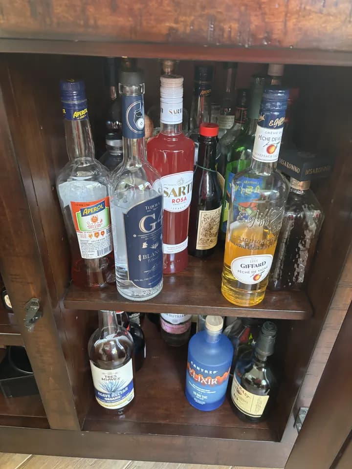 The walnut cabinet: Aperol, G4 Blanco, Sarti Rosa, Giffard pêche and Disaronno
